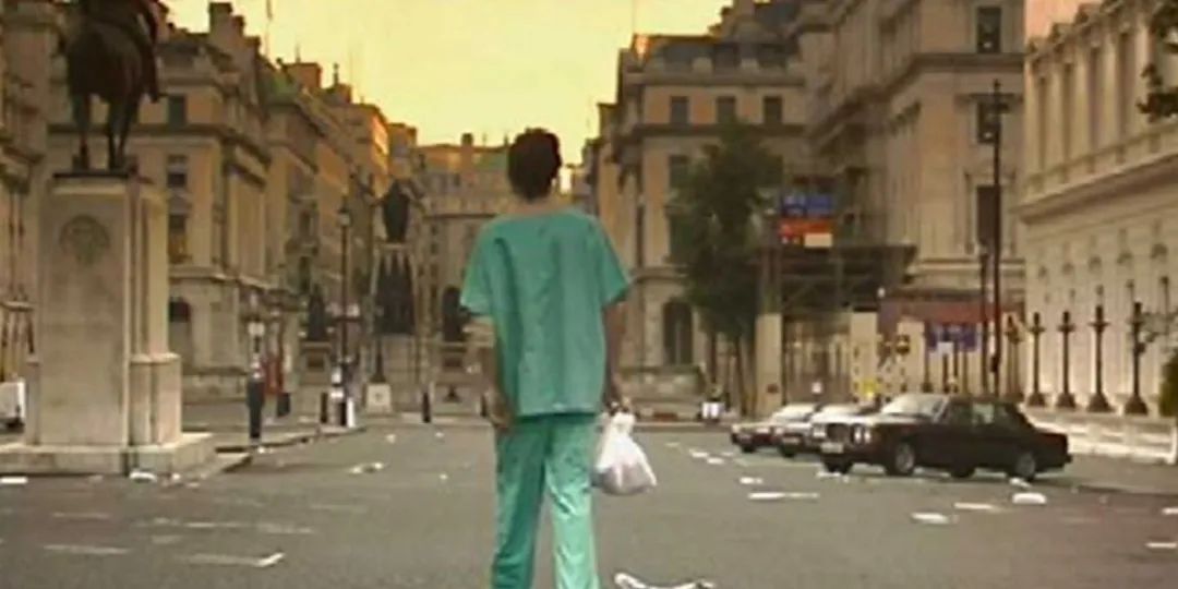 Cillian Murphy walking through a deserted London street in 28 Days Later.